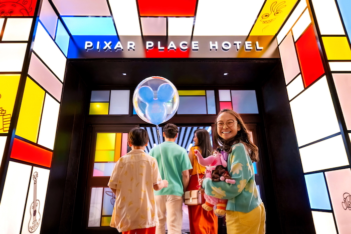 Pixar Place Hotel with Family in Front of it