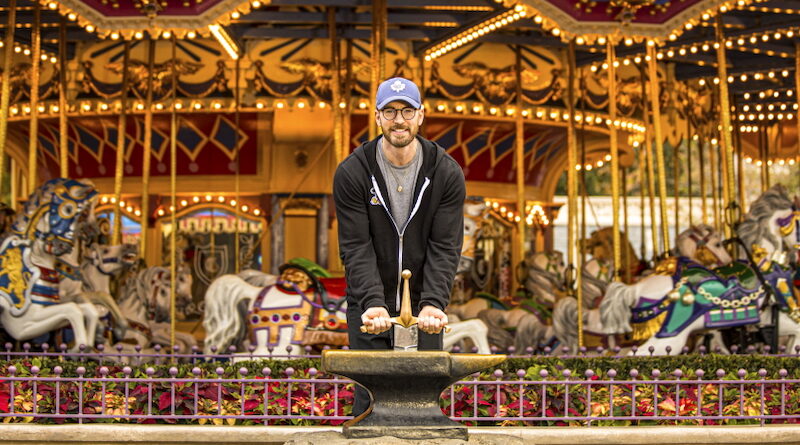 Actor Chris Evans Raising the Sword in the Stone at Magic Kingdom