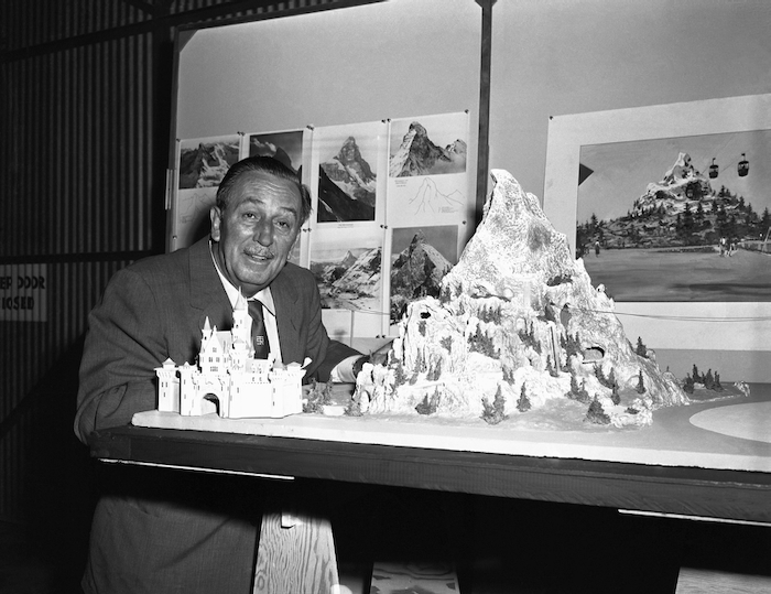 Walt Disney with a Matterhorn Bobsleds model